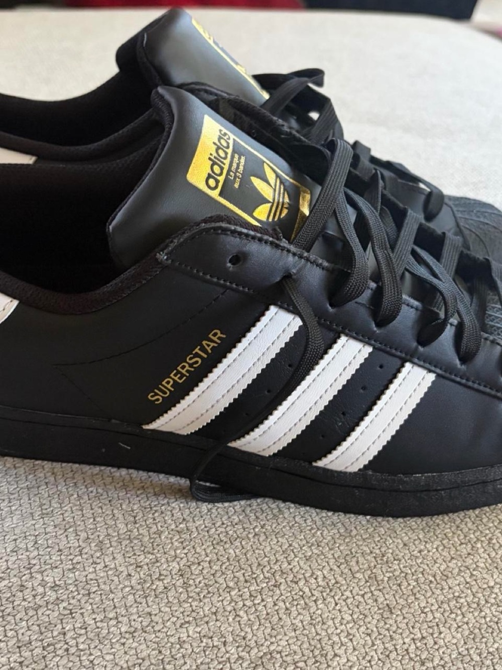 adidas Superstar Men's Sneakers in Black with White Stripes and Gold Accents